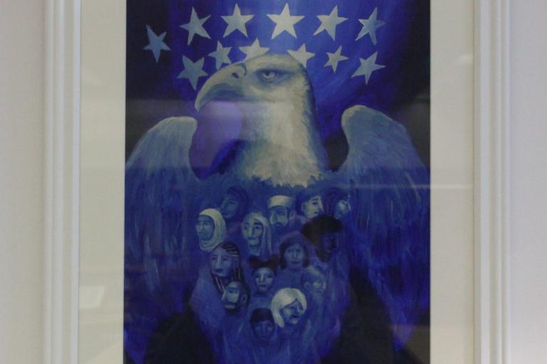different shades of blue with a large bald eagle made up of faces from different backgrounds