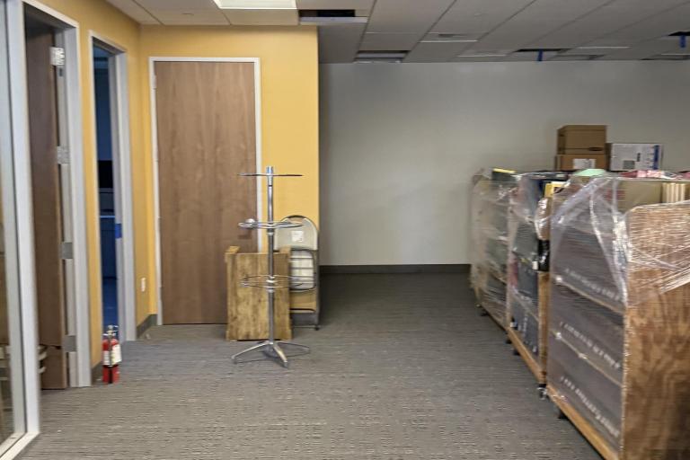 Photo of wrapped book carts within the cleared interior of the Palm Springs Law Library.