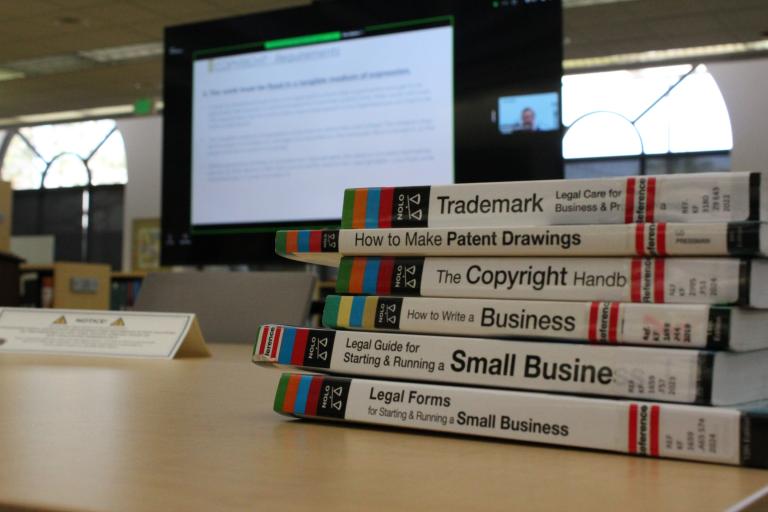 Small business books in front of the ICLS presentation.