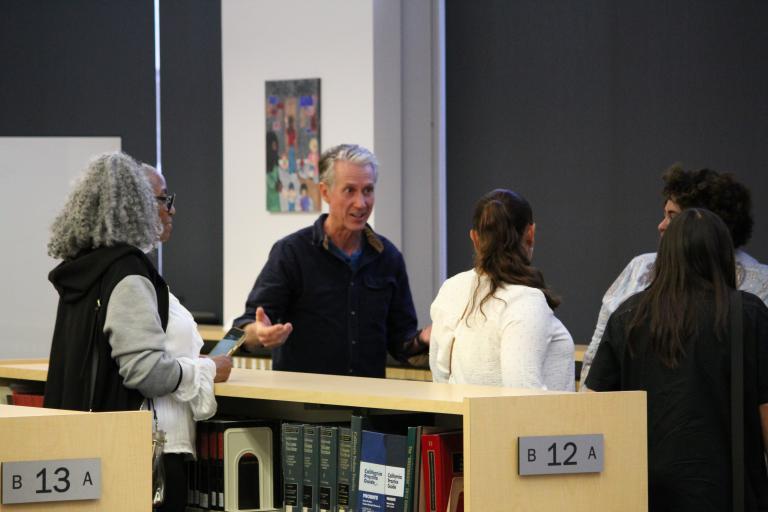 A group of patrons discussing the artwork.