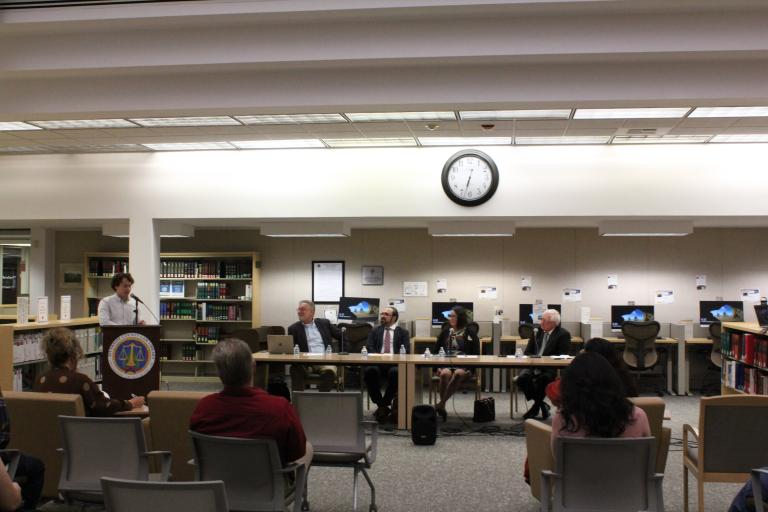 A library staff member delivers opening remarks.