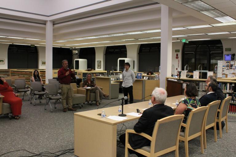 A member of the public asks the panelists a question.