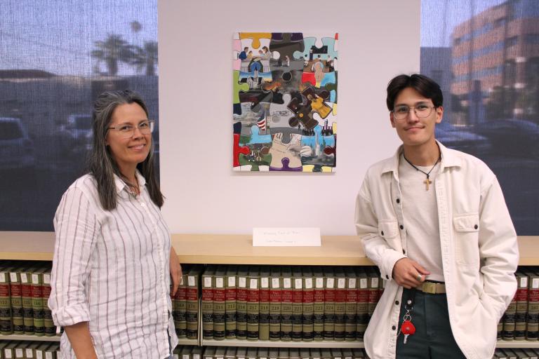 First place 2026 winner Liam Montes with his mom and artwork, "Missing Piece of Peace"