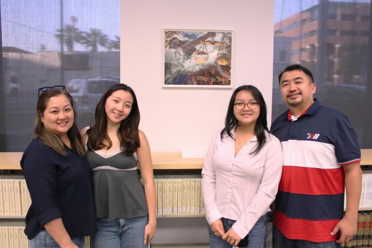 Third place winner Julianne Lim with her family and artwork, "Ad Meloria"