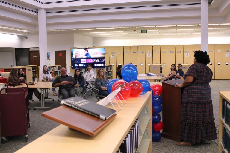 Entrants and their families listen as Administrative Officer Lauren Patterson makes opening remarks.