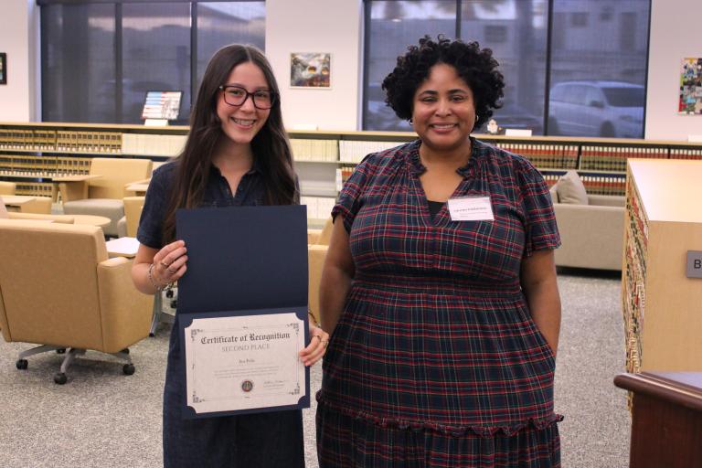 Administrative Officer Lauren Patterson presents the second place certificate to Ava Felis.