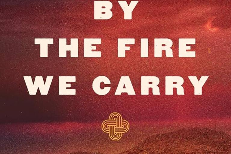Cover of the book, "By the Fire We Carry" by Rebecca Nagle featuring a red-tinged Oklahoma landscape.