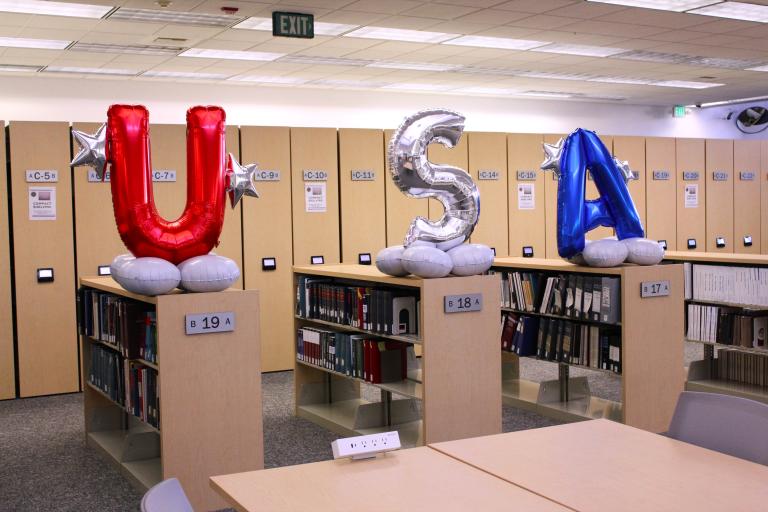 Large "U S A" balloons in the Library.