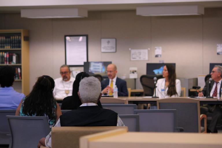 Attendees watch the panel