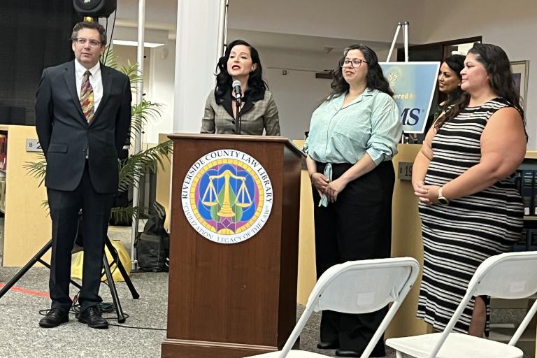 Executive Director Tessie Solorzano and attorneys from Inland Counties Legal Services accept the Community Partnership Award