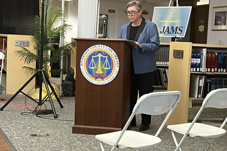 Past Board President Judge Micelle Levine presents the dedication of the printing center in honor of former Library Assistant Johnny Graham