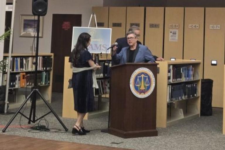 User Experience Librarian Andy Valencia presents Judge Michelle Levine with the Distinguished Service Award. Courtesy of Daisy De Anda.
