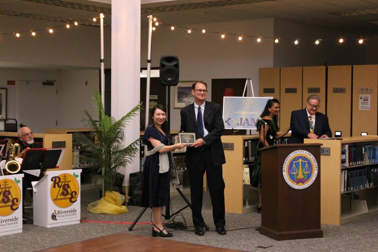 Riverside Legal Aid Deputy Director Ernie Reguly accepts the Community Partnership Award