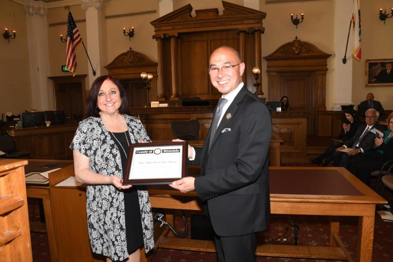 RCLL Board President Jack Lucky receives a Certificate of Recognition of the Victor Miceli Law Library grand reopening from County Supervisor Karen Spiegel