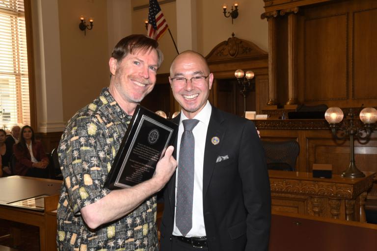 RCLL Board President Jack Lucky presents Victor Miceli Jr. a recognition plaque