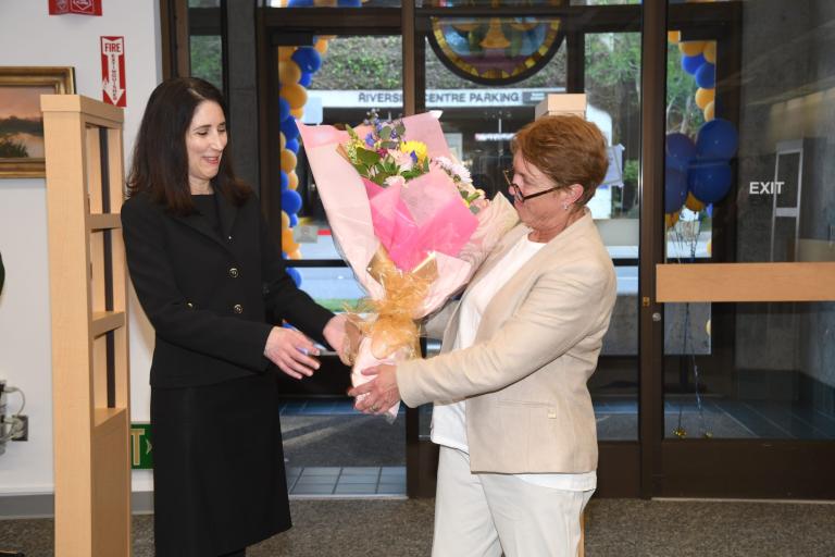 RCLL Past Board President Judge Michele Levine (Ret.) presents Chief Justice Patricia Guerrero w/ a floral bouquet