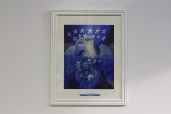 different shades of blue with a large bald eagle made up of faces from different backgrounds
