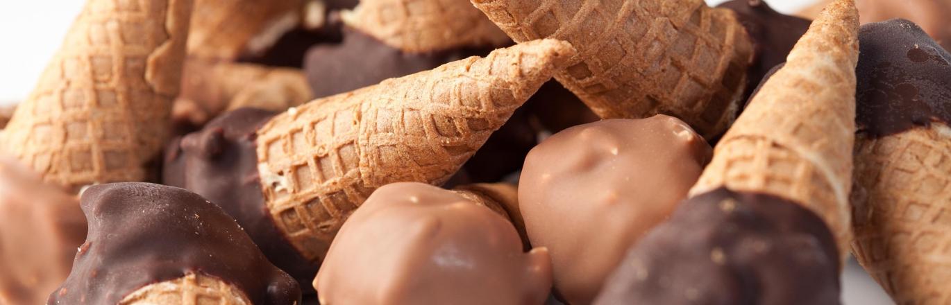 A stack of chocolate-dipped ice cream waffle cones.