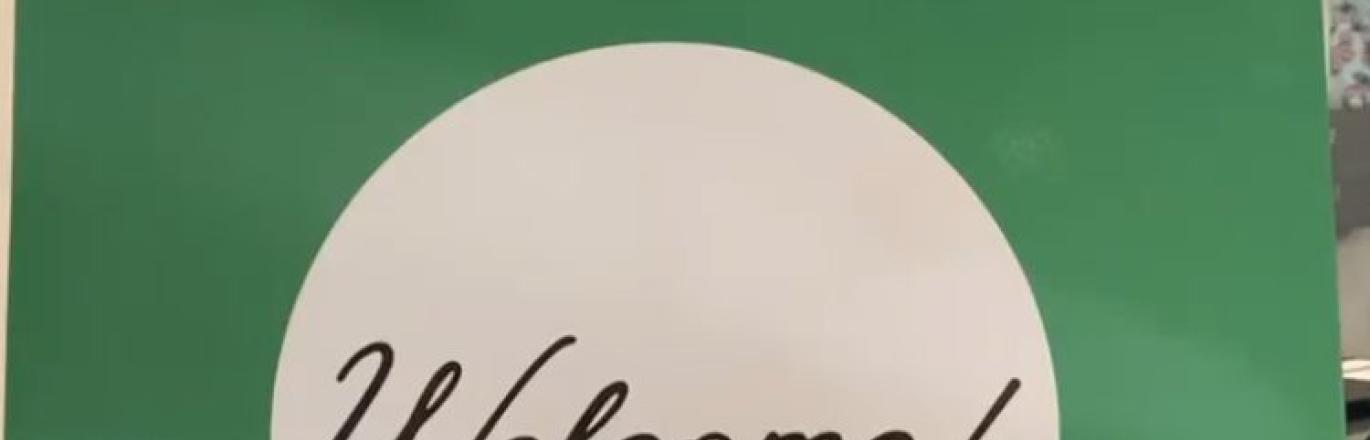 green poster board sign that says "SCALL Welcome"