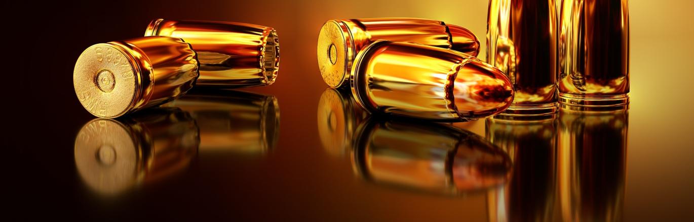 3 pairs of 2 golden/copper like bullets, 2 pairs on their sides and one pair upright on a reflective surface