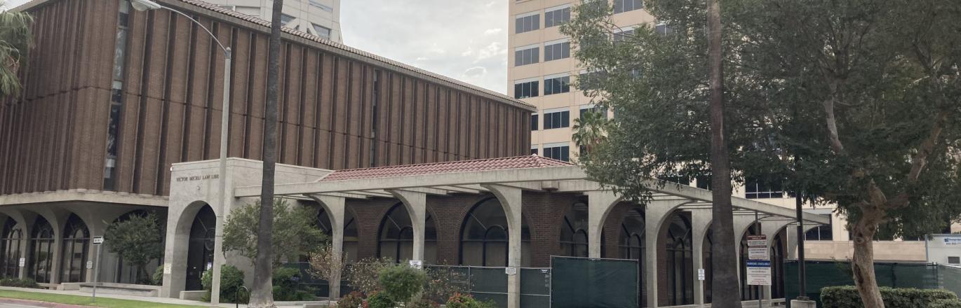 Photo of Riverside County Law Library exterior with chain link fence and trailer for construction