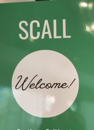 green poster board sign that says "SCALL Welcome"
