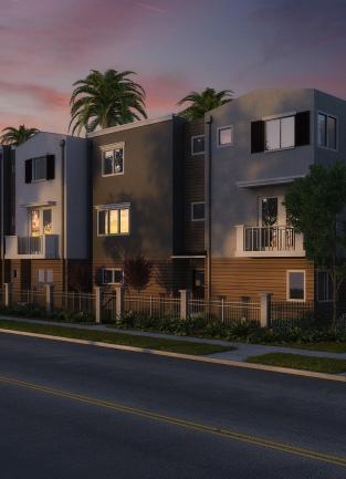 a line of condos at dusk with palm trees out front